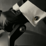 Gloved hand gripping motorcycle handlebar