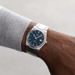 Silver stainless steel wristwatch with blue dial