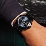 Black chronograph watch on wrist