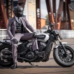 Person in suit wearing helmet on black motorcycle