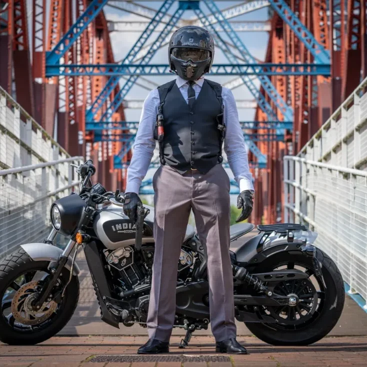 Biker posing on urban bridge